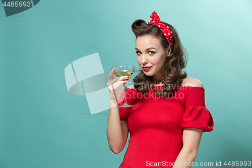 Image of Beautiful young woman with pinup make-up and hairstyle. Studio shot on white background