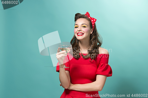 Image of Beautiful young woman with pinup make-up and hairstyle. Studio shot on white background