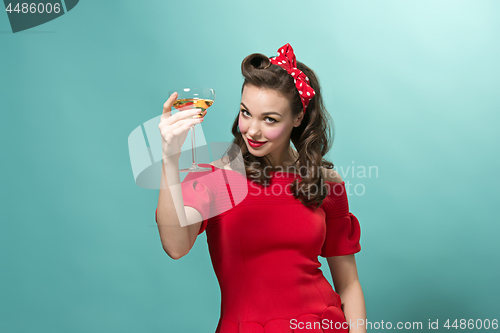 Image of Beautiful young woman with pinup make-up and hairstyle. Studio shot on white background