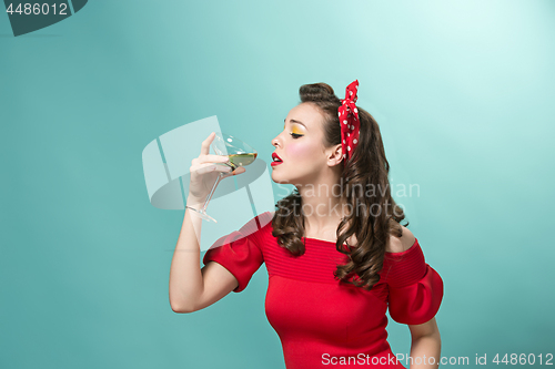 Image of Beautiful young woman with pinup make-up and hairstyle. Studio shot on white background