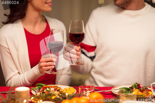 Image of close up of couple drinking red wine on christmas