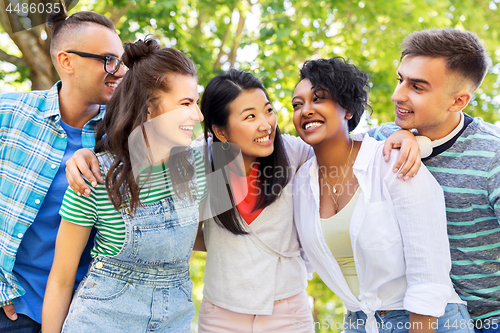 Image of happy international friends hugging in park