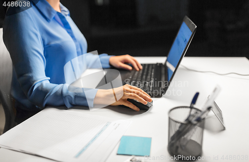 Image of close up of businesswoman using computer mouse