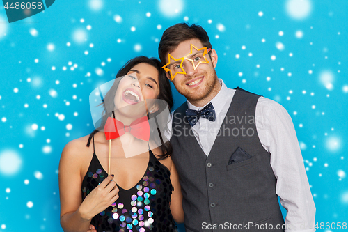 Image of happy couple with party props having fun
