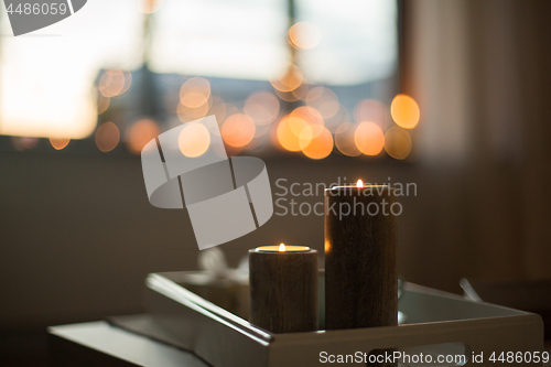 Image of close up of candles on table at home