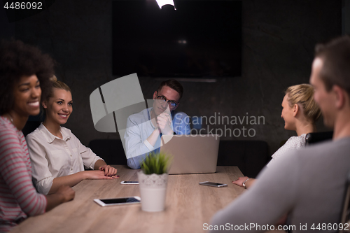 Image of Multiethnic startup business team in night office