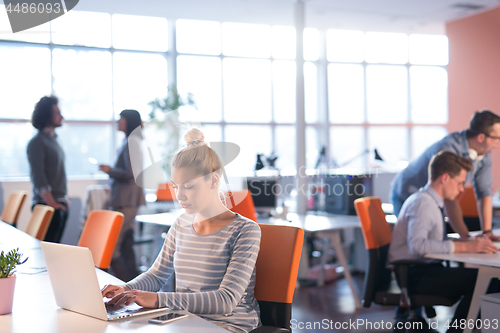 Image of businesswoman using a laptop in startup office