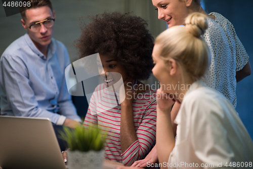 Image of Multiethnic startup business team in night office