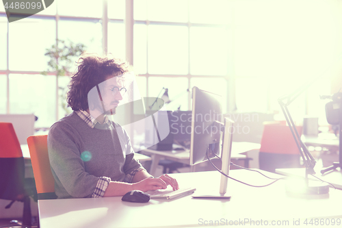 Image of businessman working using a computer in startup office