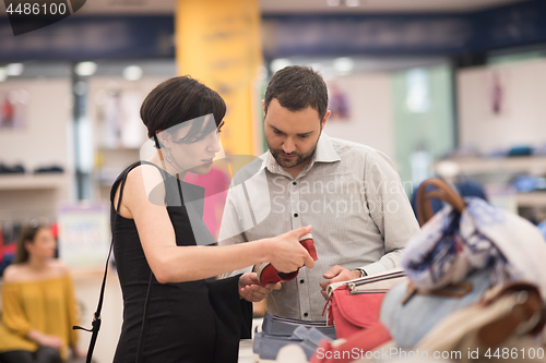 Image of couple chooses shoes At Shoe Store