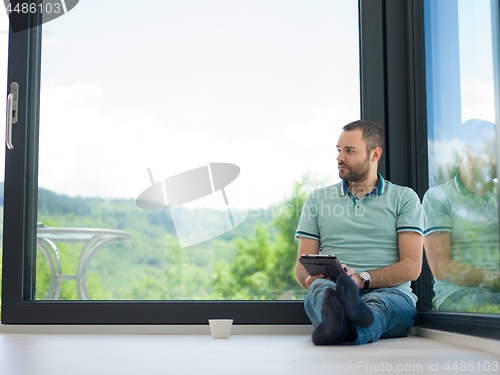 Image of man on the floor enjoying relaxing lifestyle