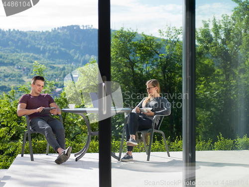 Image of couple enjoying morning coffee and breakfast