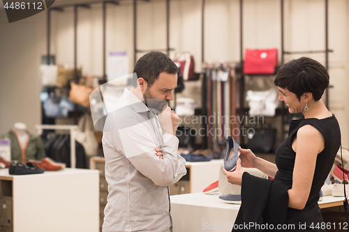 Image of couple chooses shoes At Shoe Store