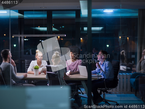 Image of Multiethnic startup business team in night office