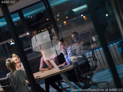 Image of Multiethnic startup business team in night office