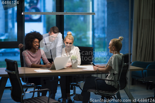 Image of Multiethnic startup business team in night office