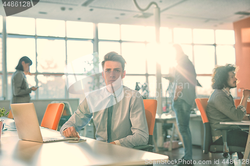 Image of businessman working using a laptop in startup office