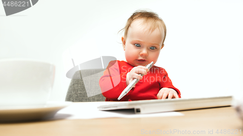 Image of Happy child baby girl toddler sitting with keyboard of computer isolated on a white background