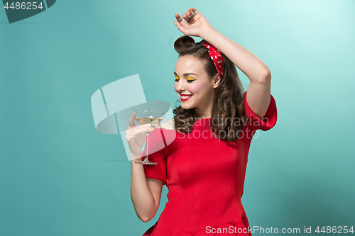 Image of Beautiful young woman with pinup make-up and hairstyle. Studio shot on white background