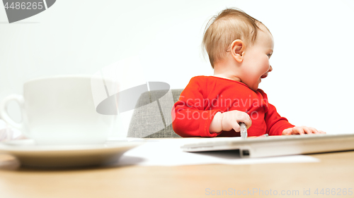Image of Happy child baby girl toddler sitting with keyboard of computer isolated on a white background
