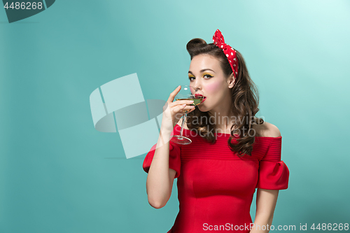 Image of Beautiful young woman with pinup make-up and hairstyle. Studio shot on white background