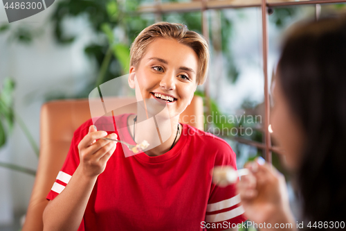 Image of female friends eating at restaurant