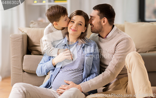 Image of happy family with pregnant mother at home