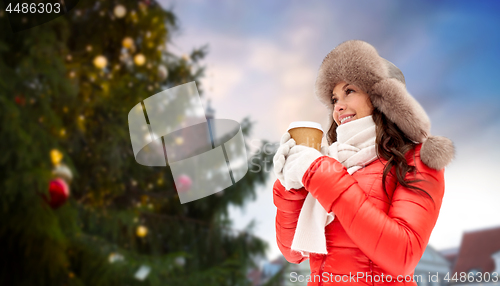 Image of woman with coffee over christmas tree in tallinn