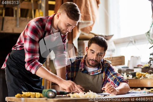 Image of two carpenters working at workshop