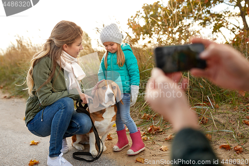 Image of family photographing by smartphone on autumn beach