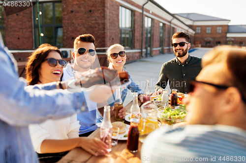 Image of friends at barbecue party on rooftop in summer