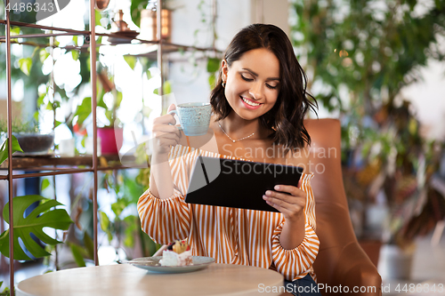 Image of happy woman with tablet pc at cafe or coffee shop