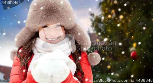 Image of woman with snow over christmas tree at tallinn