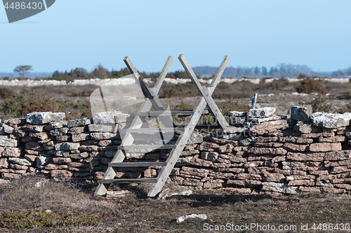 Image of Old wooden stile by a stone wall