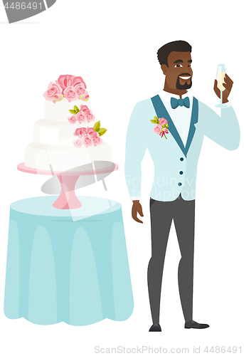 Image of Groom standing near cake with glass of champagne.