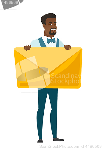 Image of Smiling groom holding a big envelope.