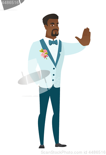 Image of African-american groom showing stop hand gesture.