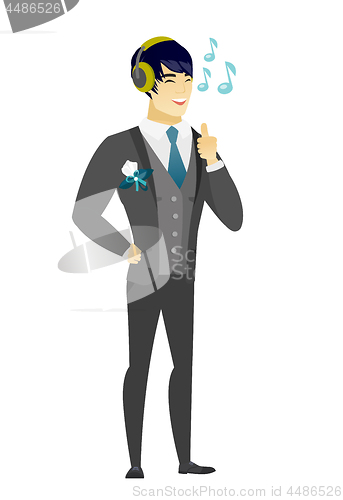 Image of Groom listening to music in headphones.