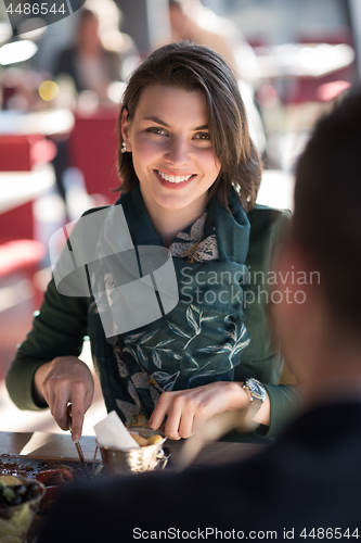 Image of Closeup shot of young woman and man having meal.