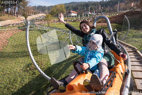 Image of mother and son enjoys driving on alpine coaster