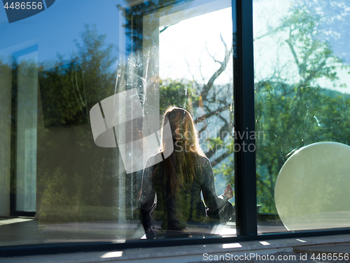 Image of young woman doing morning yoga exercises