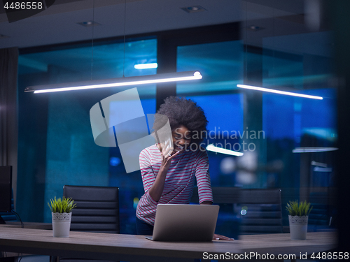 Image of black businesswoman using a laptop in startup office