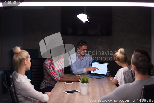 Image of Multiethnic startup business team in night office