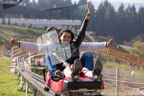 Image of couple enjoys driving on alpine coaster