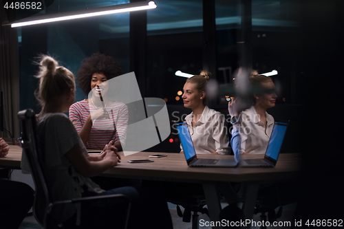 Image of Multiethnic startup business team in night office