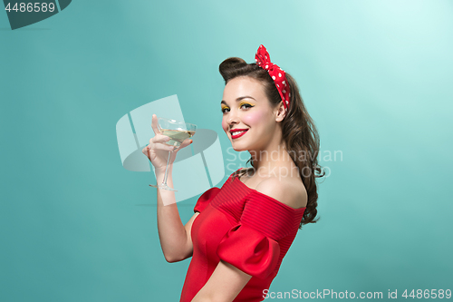 Image of Beautiful young woman with pinup make-up and hairstyle. Studio shot on white background