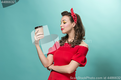 Image of Beautiful young woman with pinup make-up and hairstyle. Studio shot on white background