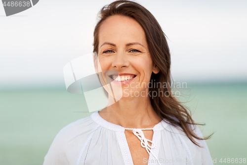 Image of happy smiling woman on summer beach