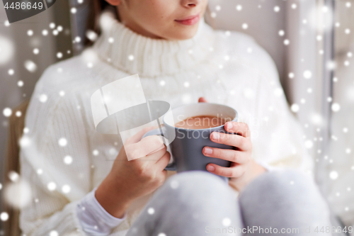 Image of close up of girl in winter sweater with cacao mug