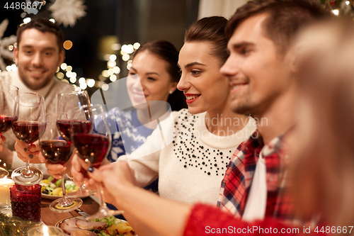 Image of friends celebrating christmas and drinking wine